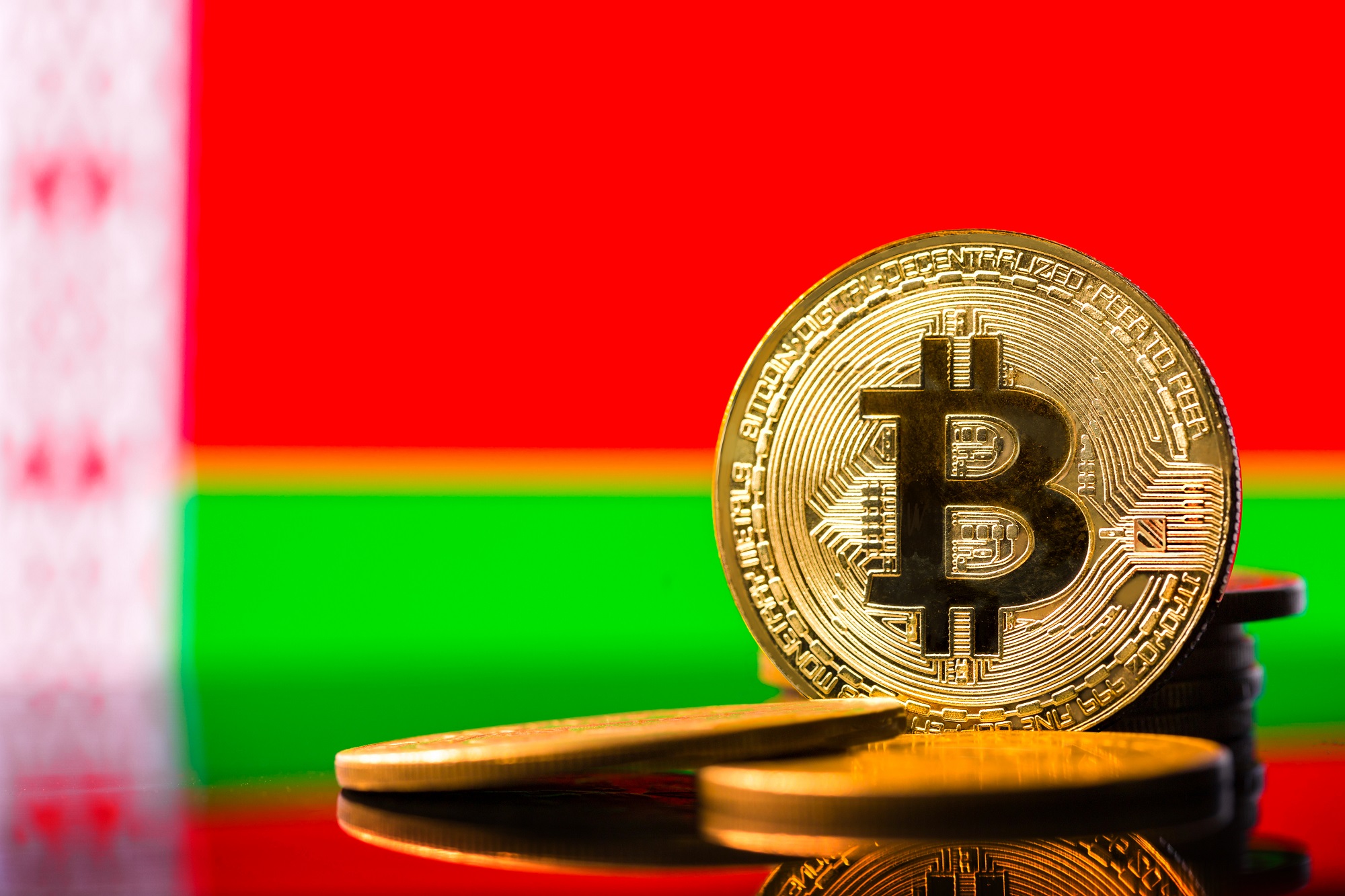 A token representing Bitcoin against the background of the flag of Belarus.
