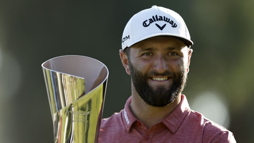 PACIFIC PALISADES, CALIFORNIA - FEBRUARY 19: Jon Rahm of Spain celebrates with the trophy after putting in to win The Genesis Invitational at Riviera Country Club on the 18th green on February 19, 2023 in Pacific Palisades, California. (Photo by Michael Owens/Getty Images)