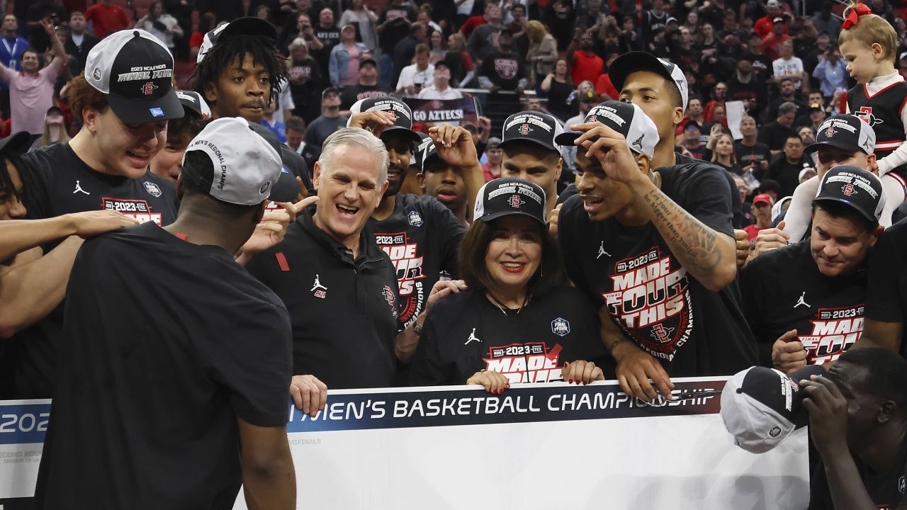 San Diego State Aztecs head coach Brian Dutcher and his team celebrate after beating the Creighton Bluejays in the Elite Eight round of March Madness.