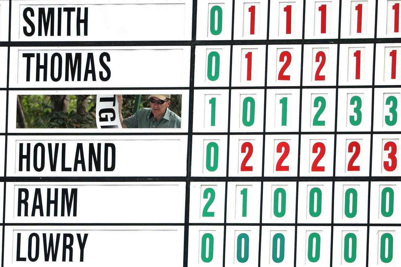 A worker updates one of the leaderboards Thursday at Augusta National.