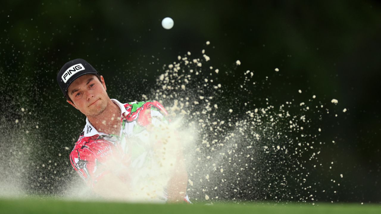 Hovland escapes a bunker on the 18th hole.