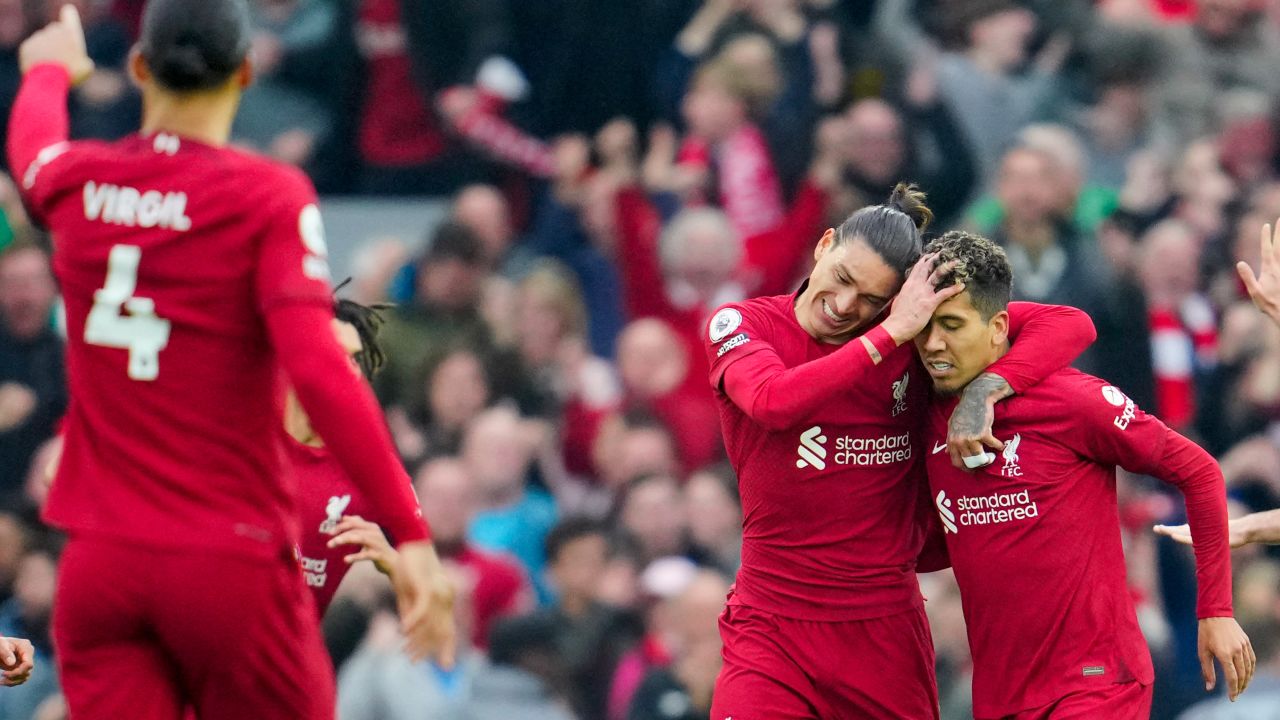 Liverpool's Roberto Firmino, right, celebrates with teammates after scoring his team's second goal.