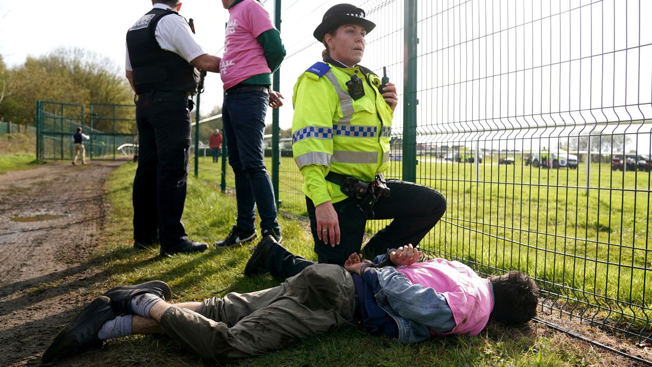 Protesters are detained by police on April 15.