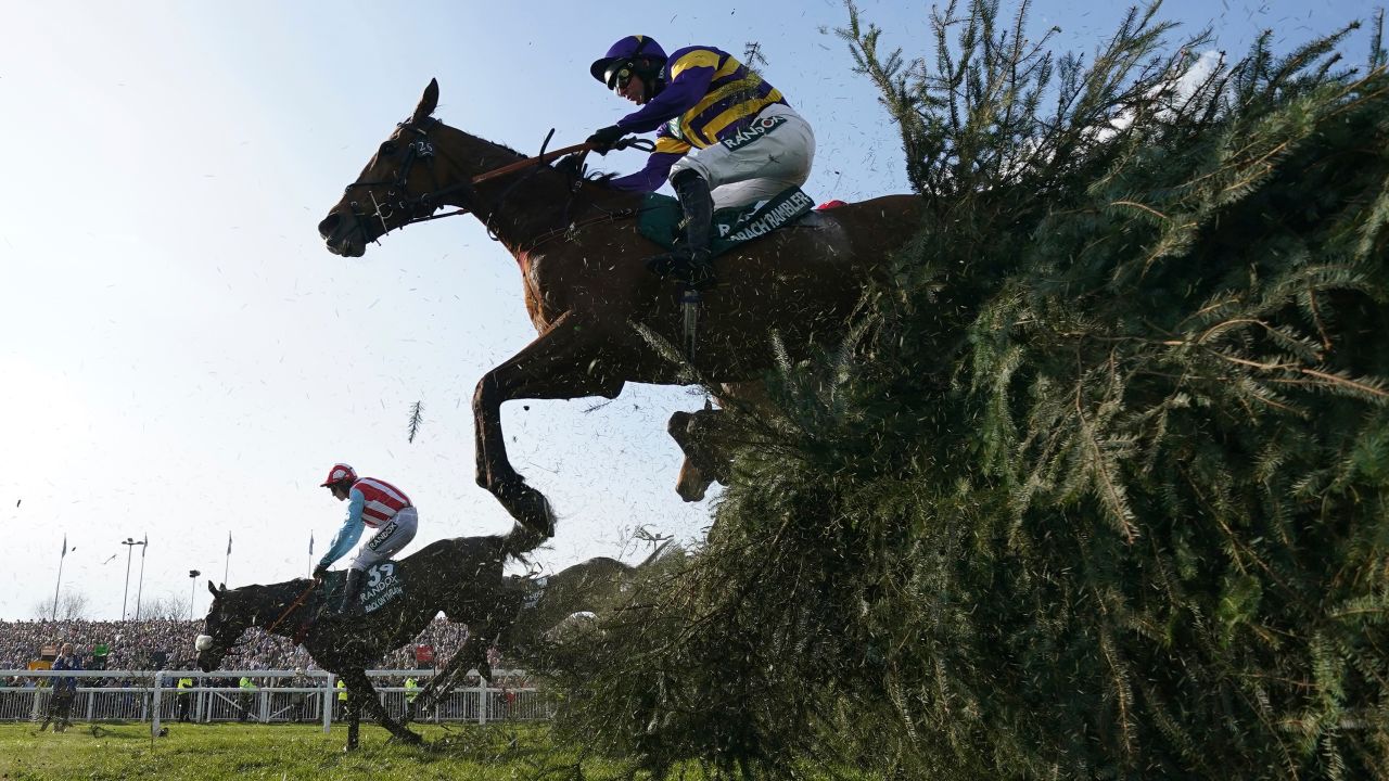 Corach Rambler ridden by Derek Fox clears a fence on their way to winning the Grand National.