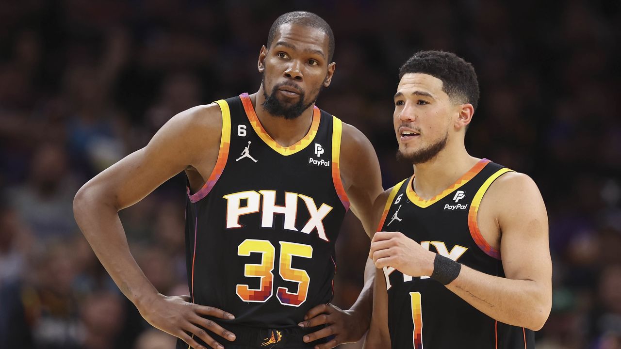 Durant and Booker talk during the second half of Game 2.