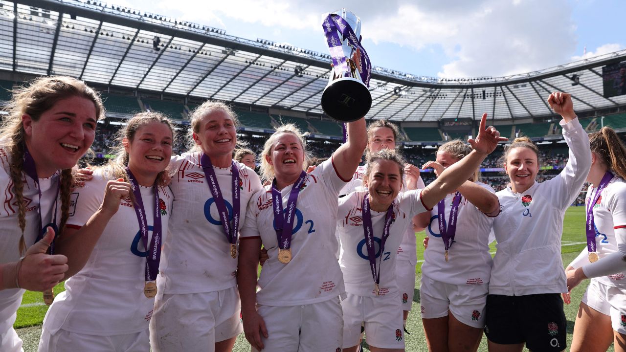 England's flanker and captain Marlie Packer celebrates with the trophy and teammates.