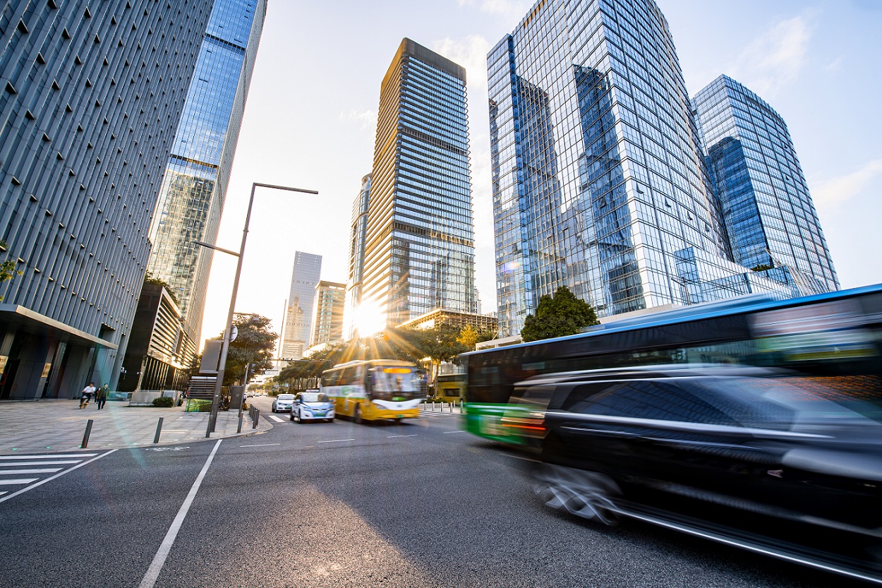 Buses pass down a busy Chinese city street