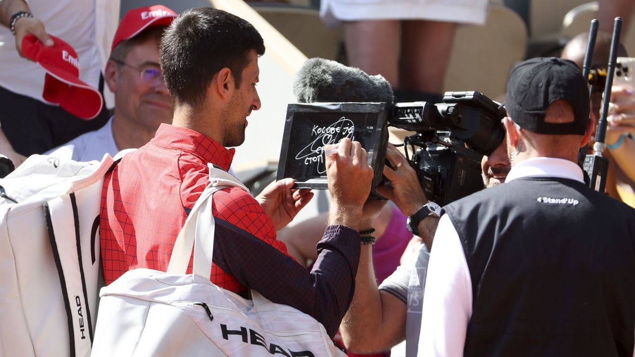 Djokovic leaves his message on the camera lens after his first-round victory at Roland-Garros.