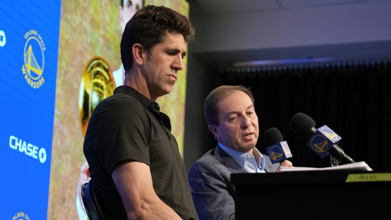 Myers speaks at a press conference next to Golden State Warriors owner Joe Lacob (right).