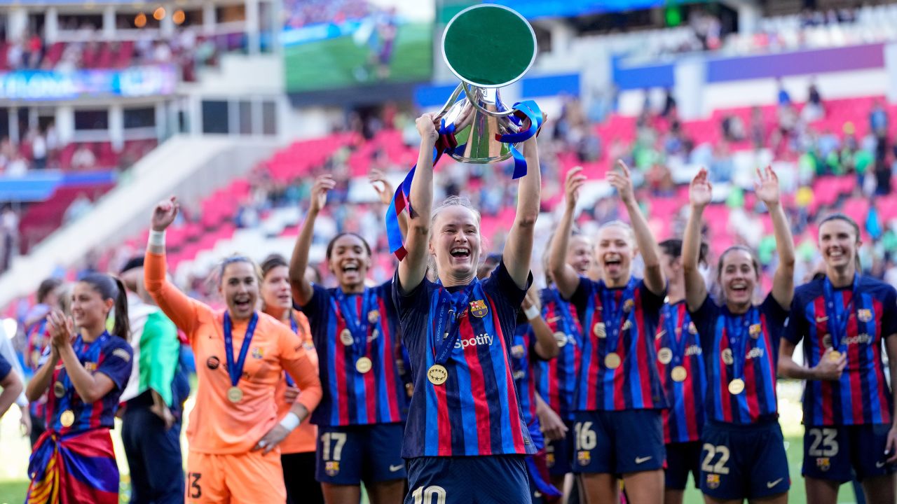 Barcelona celebrate with the trophy.