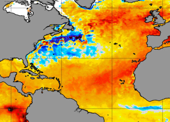 A radar map of the North Atlantic ocean showing large areas of unusually high temperatures in orange and red, with some blue spots near the east coast of North America