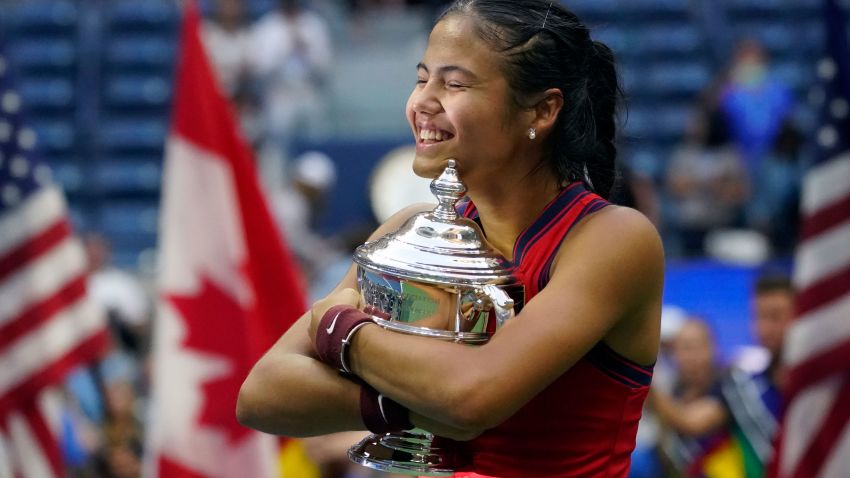 Emma Raducanu, of Britain, hugs the US Open championship trophy after defeating Leylah Fernandez, of Canada, during the women's singles final of the US Open tennis championships, Saturday, Sept. 11, 2021, in New York. (AP Photo/Elise Amendola)