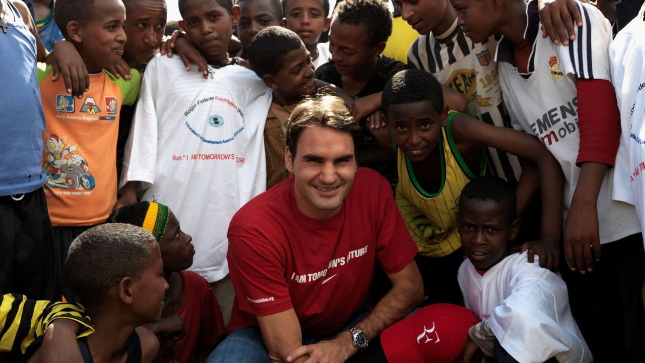 KORE ROBA, ETHIOPIA - FEBRUARY 12:  In this handout photo provided by the Roger Federer Foundation, World tennis number one Roger Federer poses with local school children during his visit to a school funded by his charity on February 12, 2010 in Kore Roba, Ethiopia. Federer was on a one-day visit to see the work carried out by the Roger Federer Foundation. Federer founded the foundation in 2003 which currently focuses on helping disadvantaged children in his mother's home country of South Africa.  (Photo by Roger Federer Foundation via Getty images)