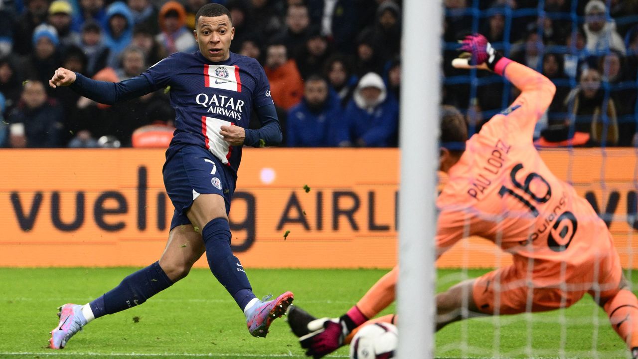 TOPSHOT - Paris Saint-Germain's French forward Kylian Mbappe scores his team's third goal during the French L1 football match between Olympique Marseille (OM) and Paris Saint-Germain (PSG) at the Velodrome stadium in Marseille, southern France on February 26, 2023. (Photo by CHRISTOPHE SIMON / AFP) (Photo by CHRISTOPHE SIMON/AFP via Getty Images)