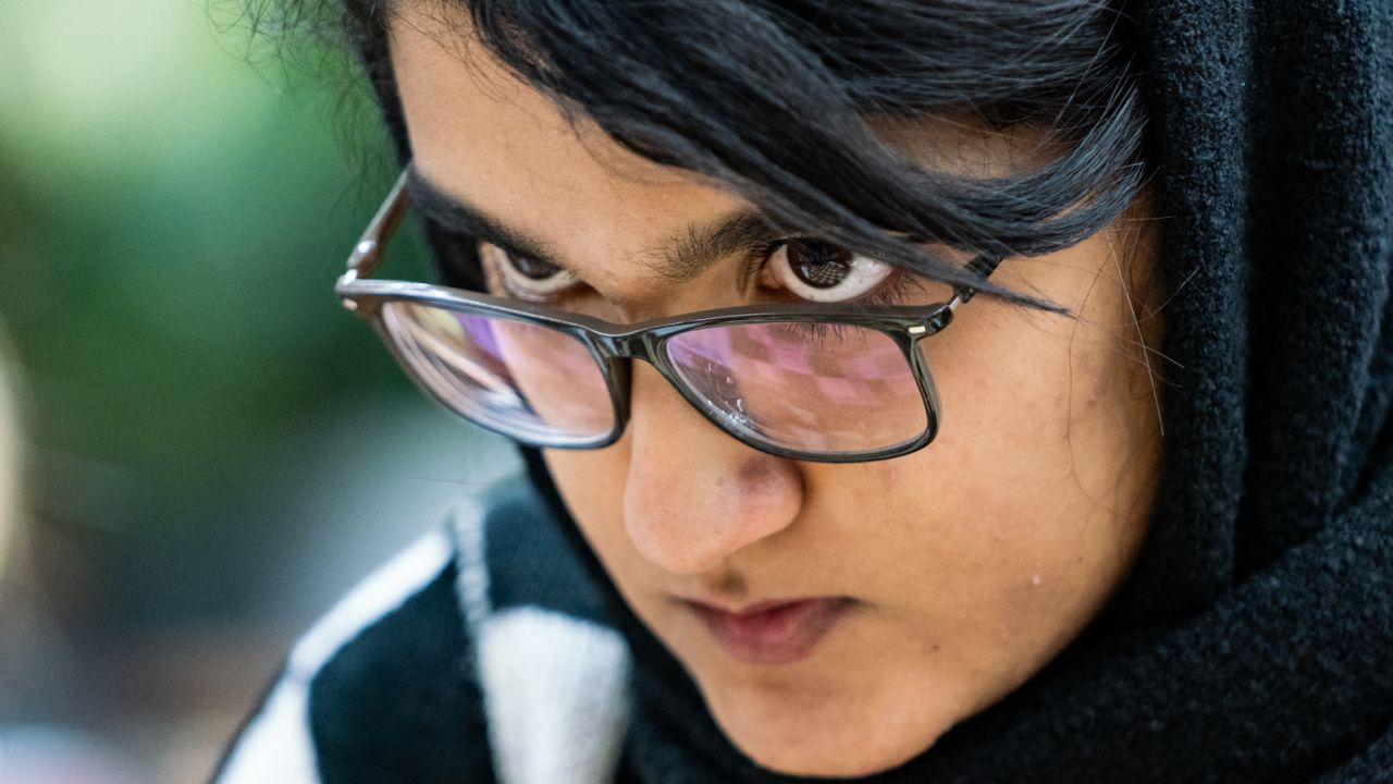 Woman International Master Mobina Alinasab gazes at the board during a game. As Emelianova describes, the "amazing reflection in the glasses (which means) you can almost see the entire position and it makes you feel like you're there."