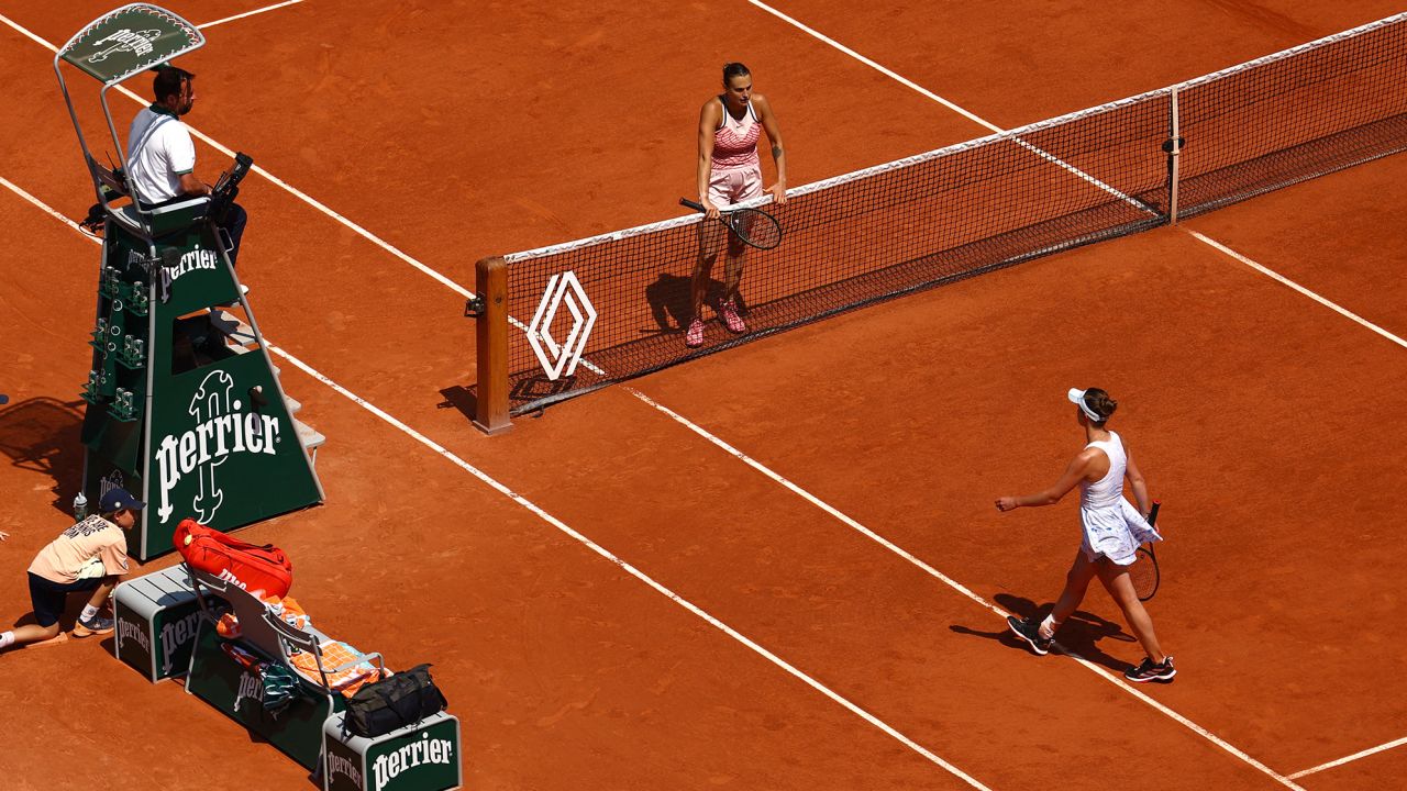 Svitolina (right) walks off the court after her defeat against Sabalenka.