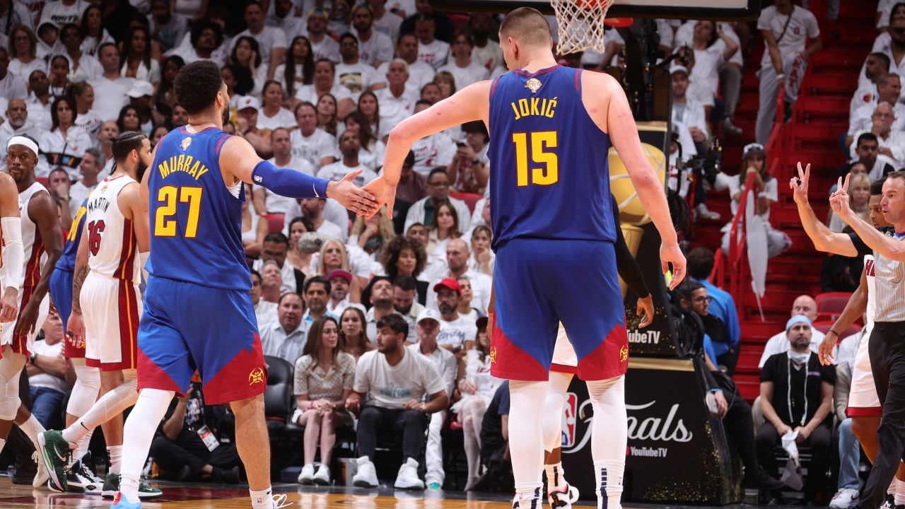 MIAMI, FL - JUNE 7: Jamal Murray #27 and Nikola Jokic #15 of the Denver Nuggets high five during Game Three of the 2023 NBA Finals against the Miami Heat on June 7, 2023 at Kaseya Center in Miami, Florida. NOTE TO USER: User expressly acknowledges and agrees that, by downloading and or using this Photograph, user is consenting to the terms and conditions of the Getty Images License Agreement. Mandatory Copyright Notice: Copyright 2023 NBAE (Photo by Nathaniel S. Butler/NBAE via Getty Images)