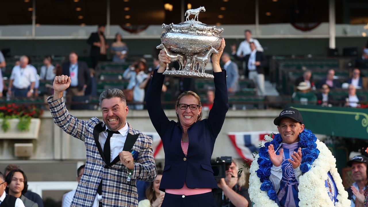 Trainer Jena Antonucci holds the winner's trophy with owner Jon Ebbert and Jockey Javier Castellano, who rode Arcangelo to victory at the 155th Belmont Stakes.