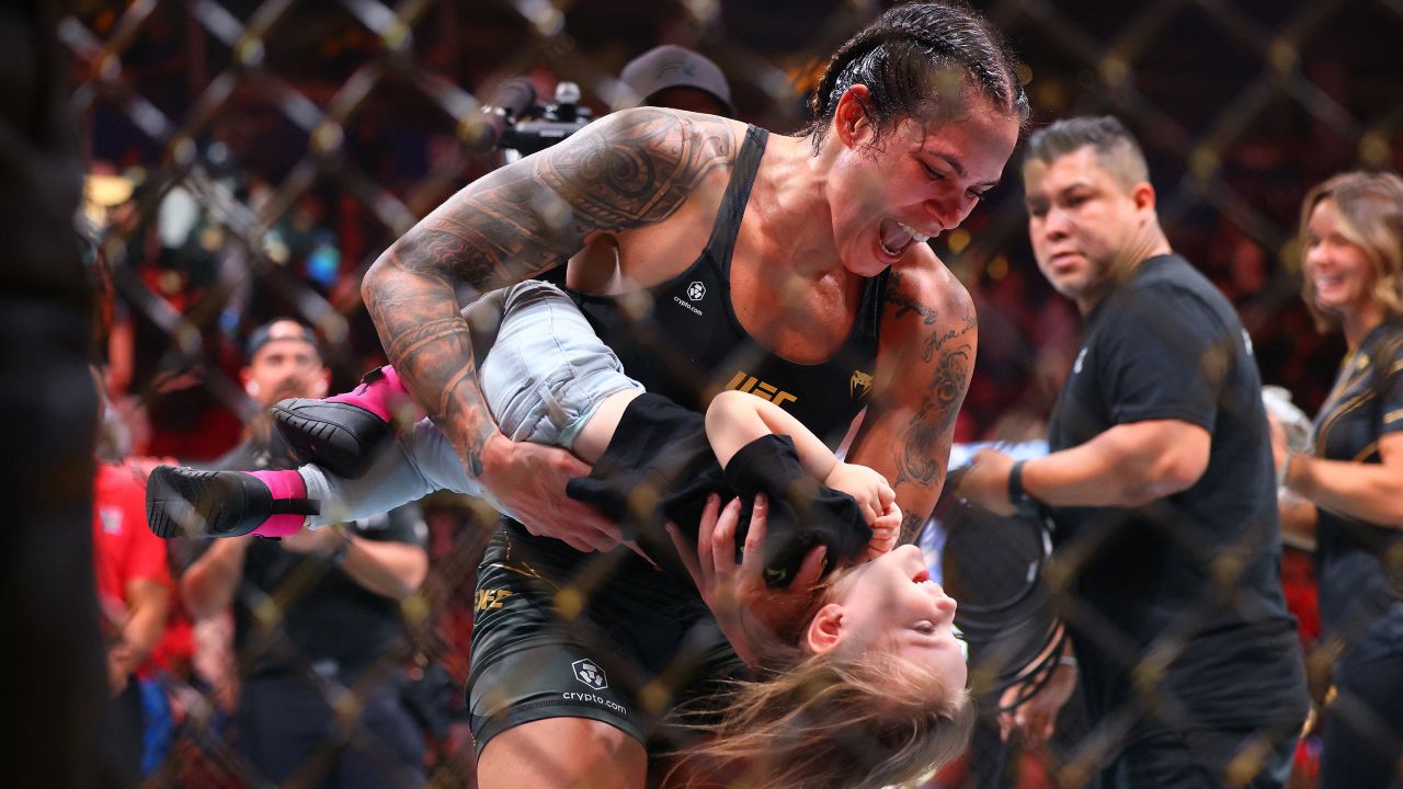 Jun 10, 2023; Vancouver, BC, Canada; Amanda Nunes celebrates her victory by decison against Irene Aldana with daughter Raegan during UFC 289 at Rogers Arena.