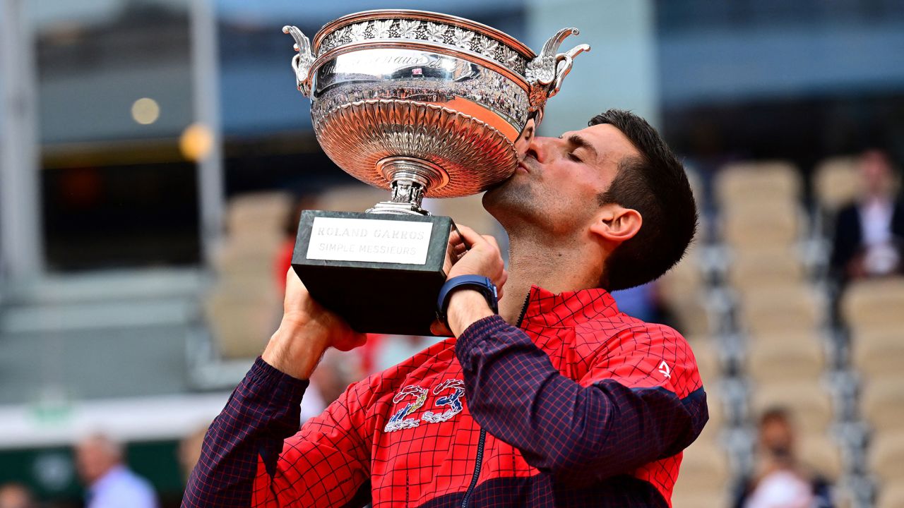 Serbia's Novak Djokovic kisses his trophy as he celebrates his victory over Norway's Casper Ruud during their men's singles final match on day fifteen of the Roland-Garros Open tennis tournament at the Court Philippe-Chatrier in Paris on June 11, 2023. (Photo by Emmanuel DUNAND / AFP) (Photo by EMMANUEL DUNAND/AFP via Getty Images)