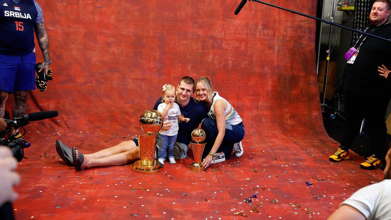 Jun 12, 2023; Denver, Colorado, USA; Denver Nuggets center Nikola Jokic (15) with his wife and daughter as they sit next to the Larry O Brien Trophy and the Bill Russell NBA Finals Most Valuable Player Award trophy after the Nuggets won the NBA championship by defeating the Miami Heat in game five of the 2023 NBA Finals at Ball Arena. Mandatory Credit: Isaiah J. Downing-USA TODAY Sports