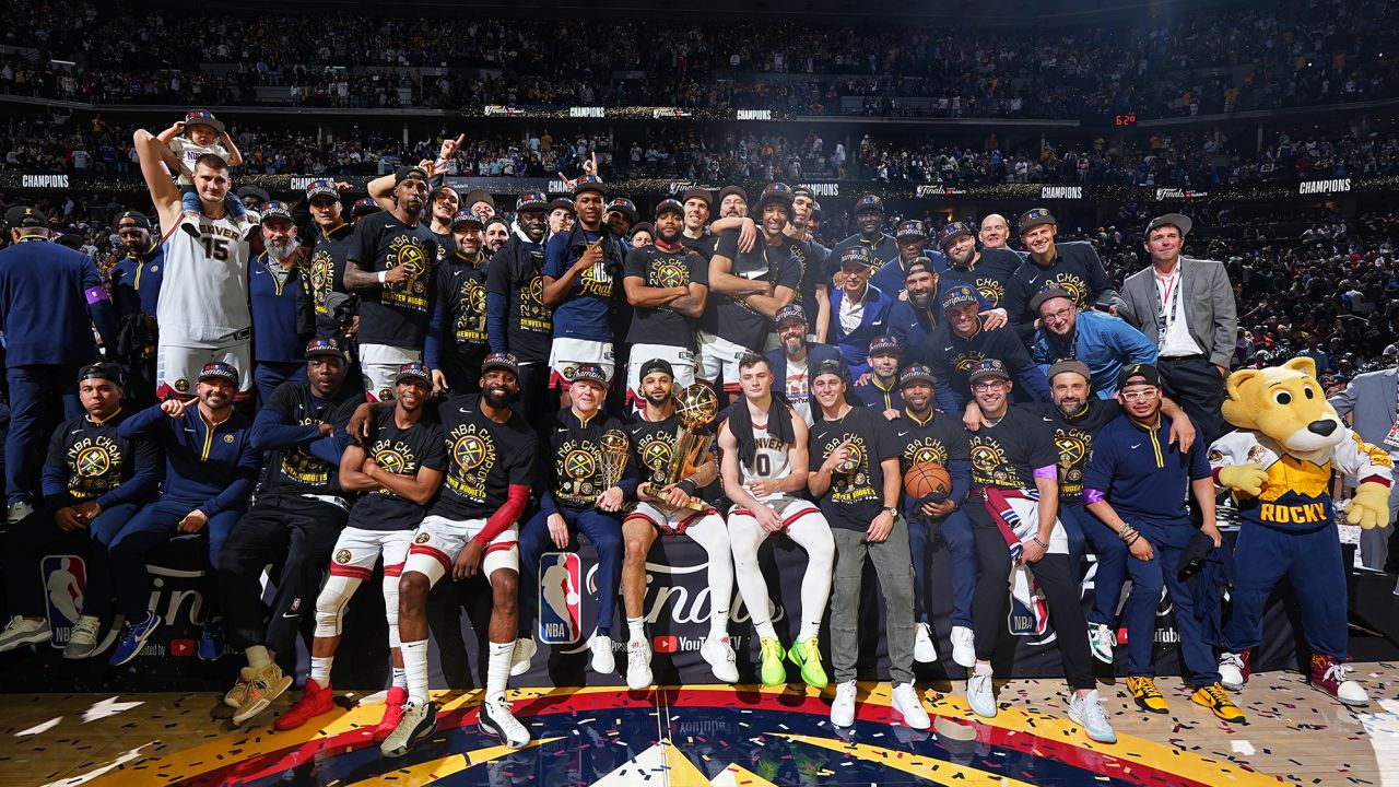 DENVER, CO - JUNE 12: The Denver Nuggets pose for a group photo on stage with the Larry O'Brien Trophy after winning Game Five of the 2023 NBA Finals against the Miami Heat on June 12, 2023 at Ball Arena in Denver, Colorado. NOTE TO USER: User expressly acknowledges and agrees that, by downloading and or using this Photograph, user is consenting to the terms and conditions of the Getty Images License Agreement. Mandatory Copyright Notice: Copyright 2023 NBAE (Photo by Garrett Ellwood/NBAE via Getty Images)