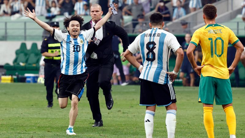 Young Chinese soccer fan gives security the slip to hug his hero Messi mid-game