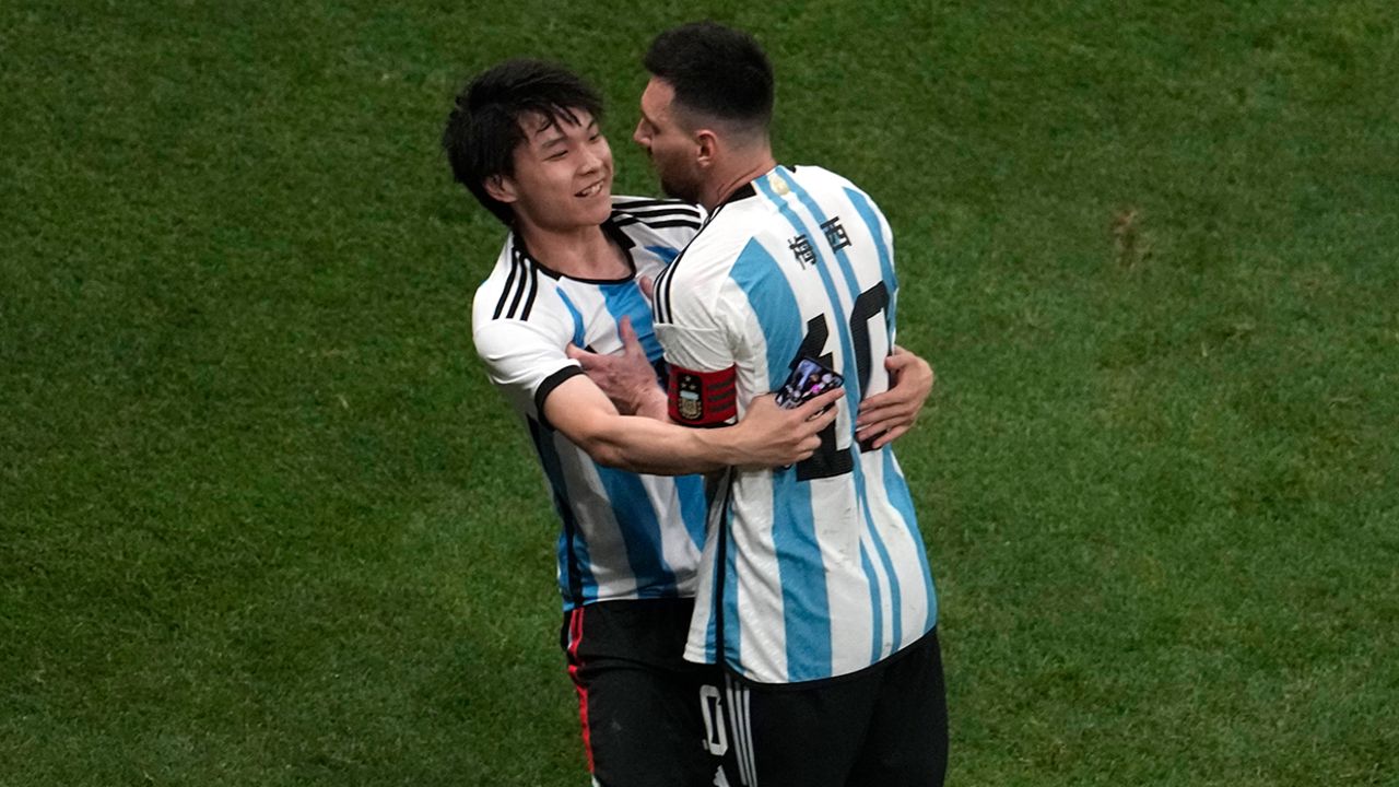 A Chinese fan runs onto the pitch to hug soccer superstar Lionel Messi during a friendly match between Argentina and Australia at the Worker's Stadium in Beijing on June 15.