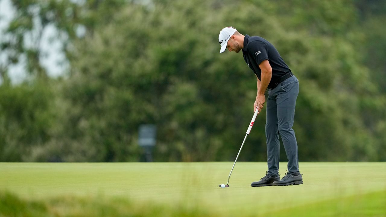 Clark putts on the 11th hole.