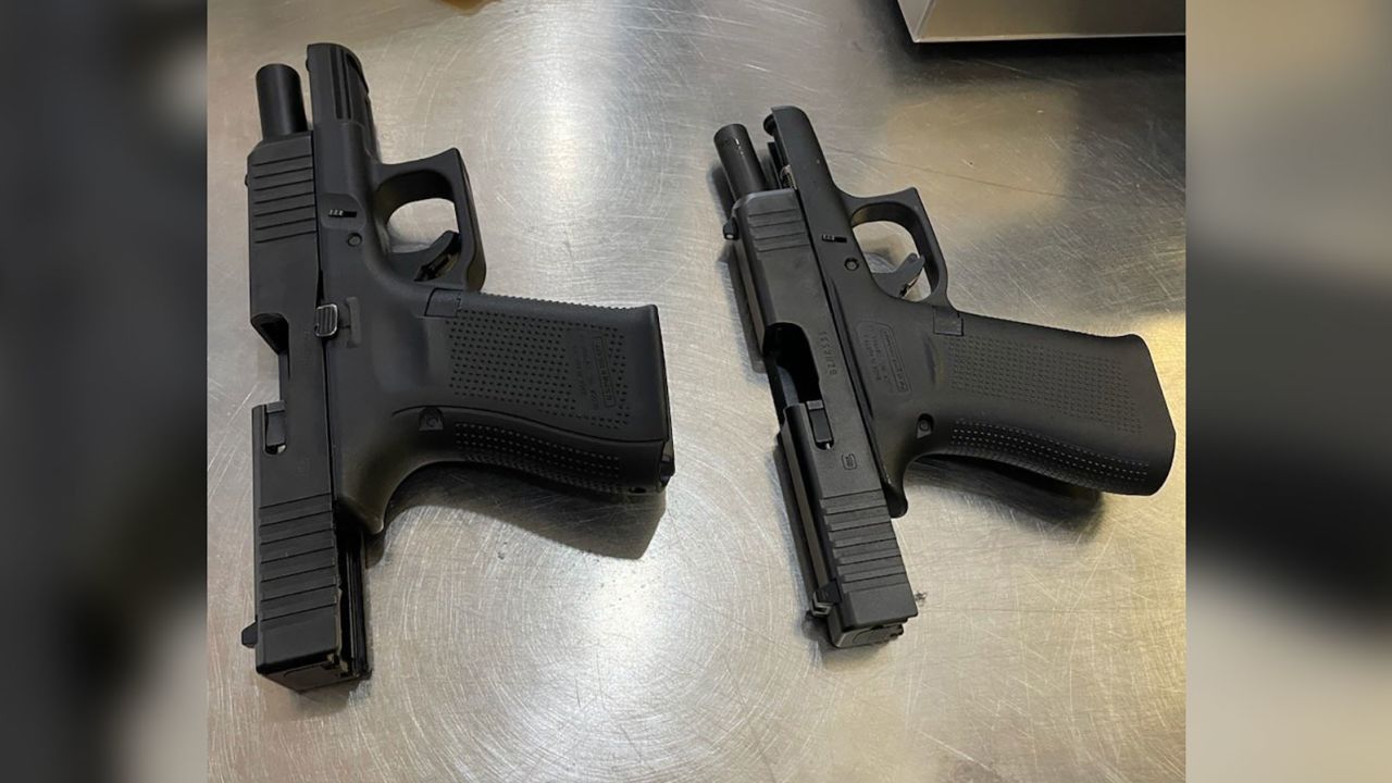 A photo from the TSA shows two loaded firearms found in the carry-on luggage of a male passenger.