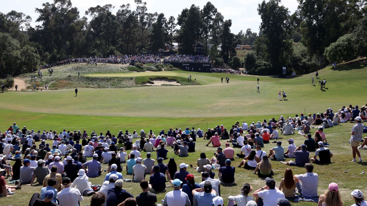 Fowler walks the sixth hole.