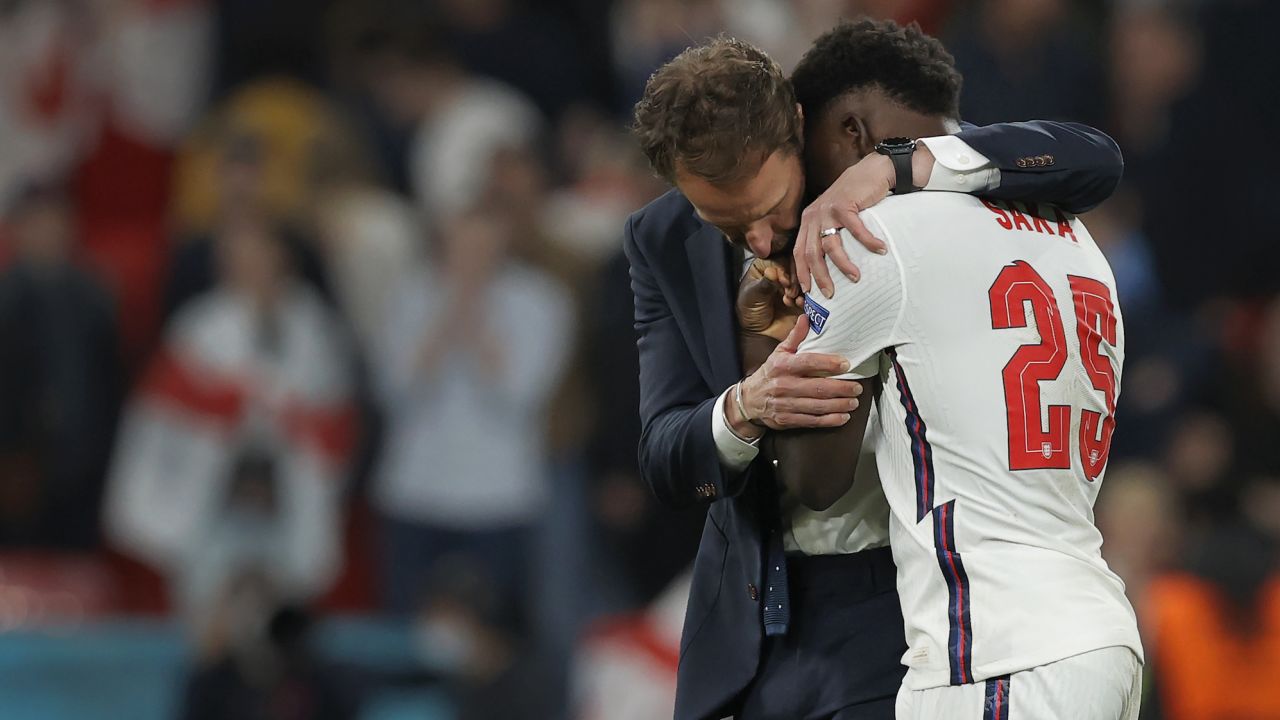 England manager Gareth Southgate consoles his player Bukayo Saka after his decisive miss in the penalty shootout gave Italy victory during the Italy v England Euro 2020 final at Wembley Stadium on July 11th 2021 in London (Photo by Tom Jenkins)