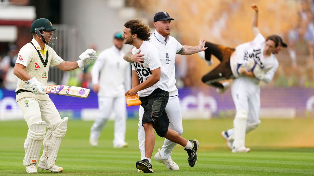 England's Ben Stokes grabs a Just Stop Oil protestor, during day one of the second Ashes Test cricket match at Lord's Cricket Ground, London, England, Wednesday, June 28, 2023.