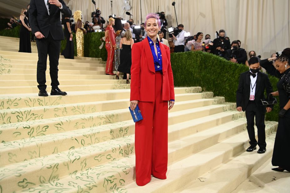 Rapinoe attends the Met Gala in 2021. She was carrying a red, white and blue clutch that read "in gay we trust."<br />