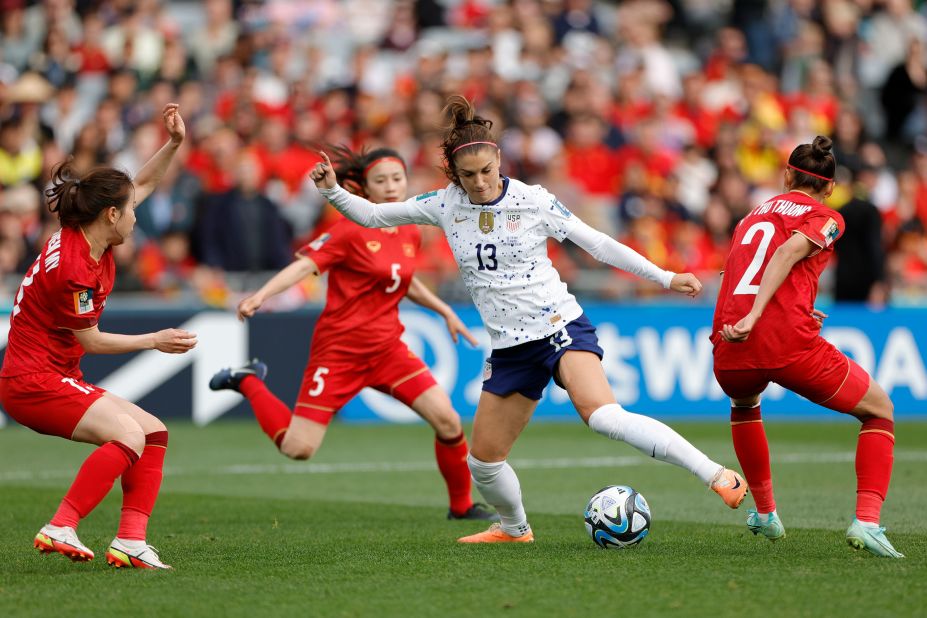 US forward Alex Morgan is surrounded by Vietnam defenders during their opening match on July 22. The United States, the two-time defending champs, won 3-0.