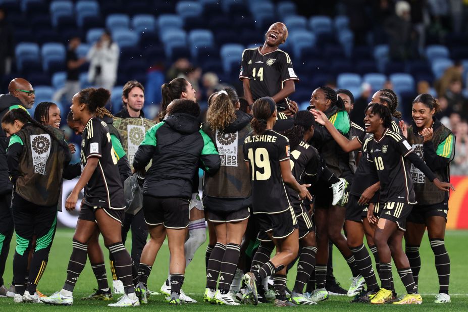 Jamaican players celebrate on Sunday, July 23, after their 0-0 draw against France earned them their country's first-ever point in the Women's World Cup.