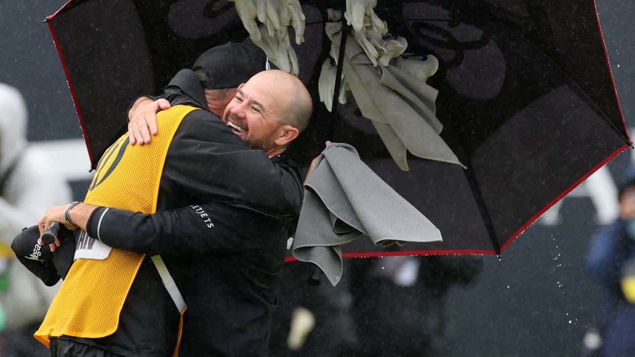 Harman embraces his caddie on the 18th green.