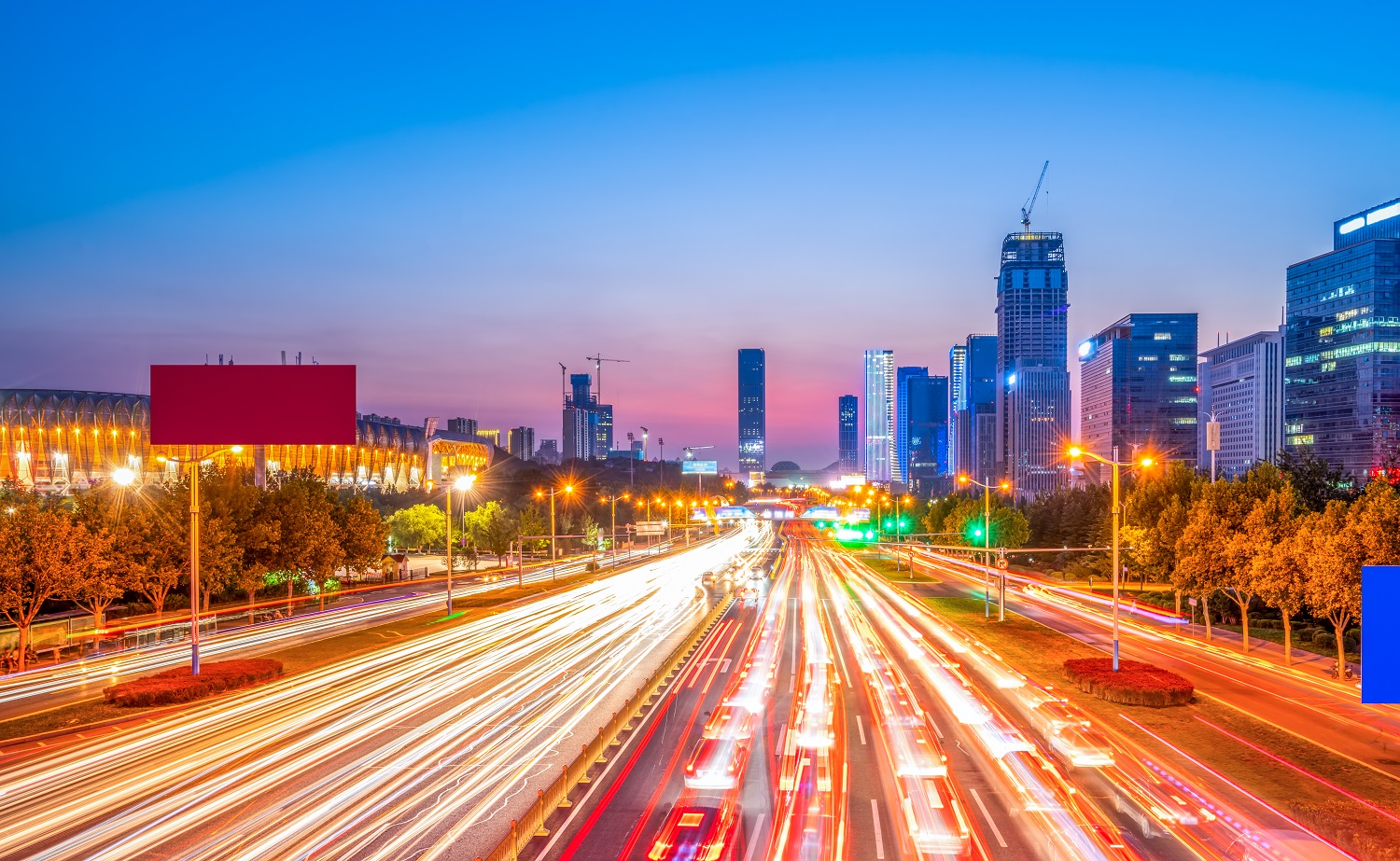 Vehicle lights on an urban road in Jinan, China.