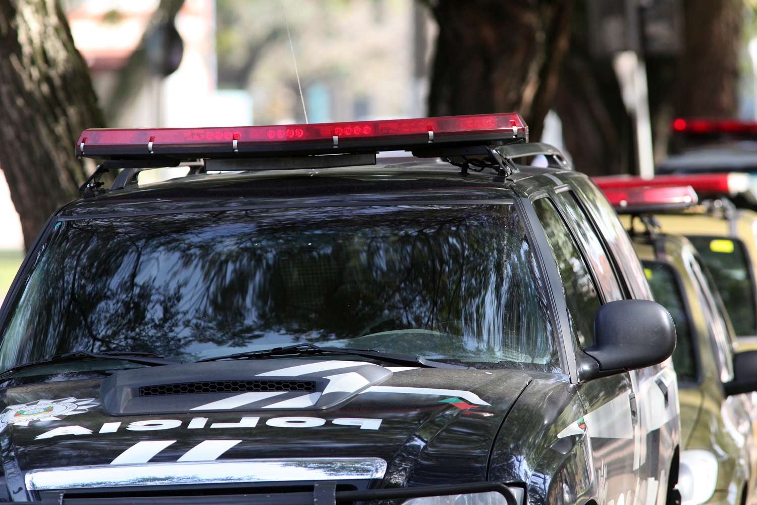 A Brazilian police car on an urban street.