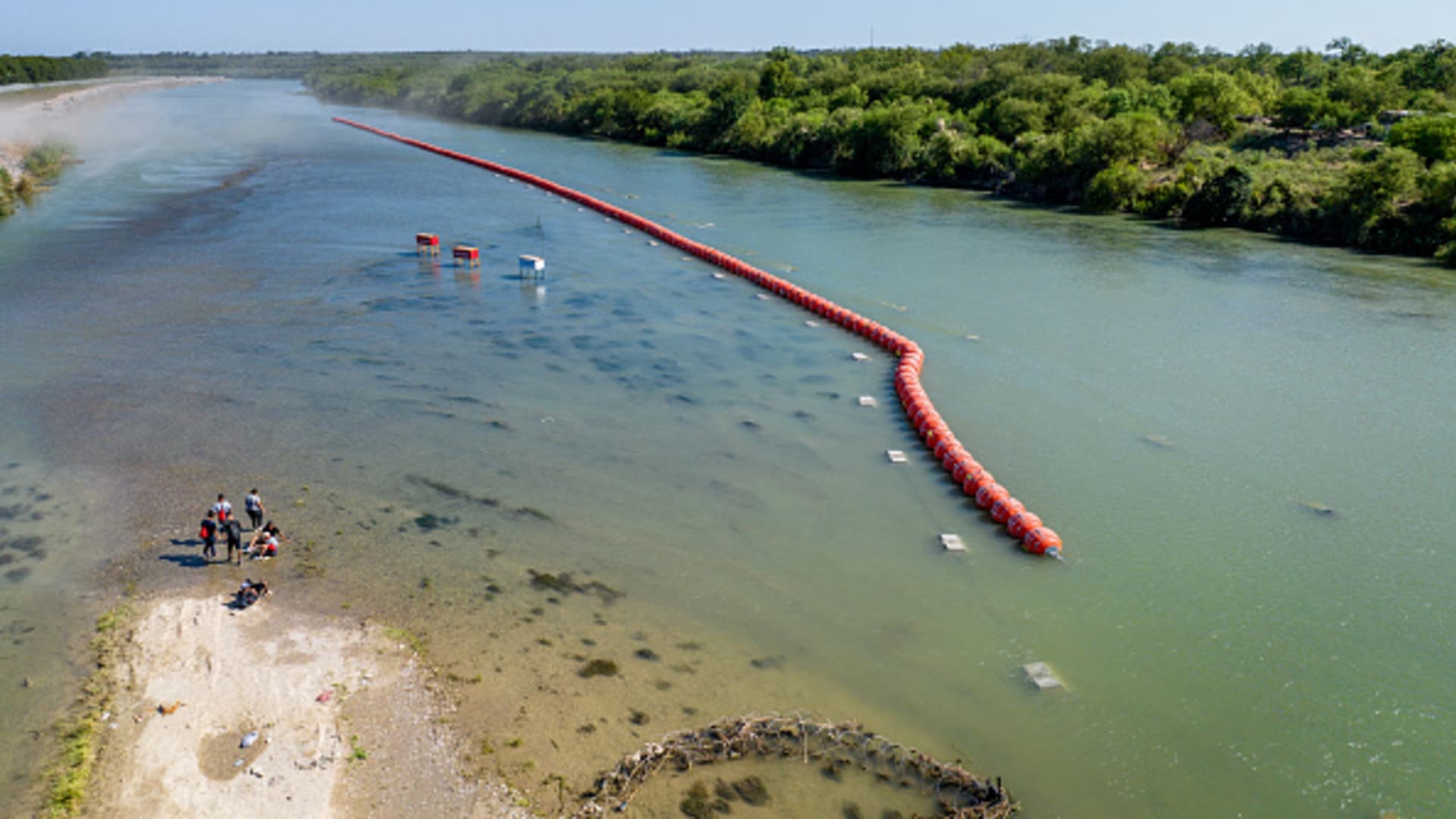 Biden administration sues Texas governor over Rio Grande buoy barrier that’s meant to stop migrants