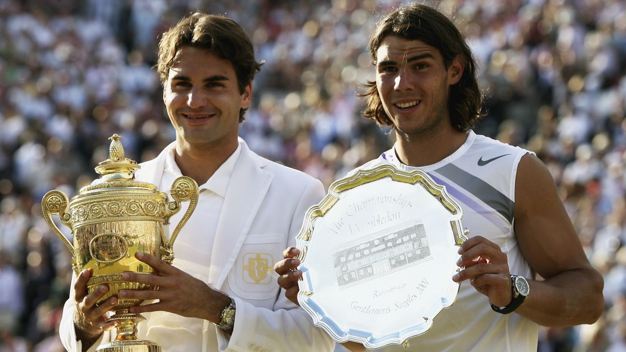 LONDON - JULY 08:  Roger Federer of Switzerland poses with the winners trophy alongside runner-up Rafael Nadal of Spain following the Men's Singles final match during day thirteen of the Wimbledon Lawn Tennis Championships at the All England Lawn Tennis and Croquet Club on July 8, 2007 in London, England. Roger Federer claims his fifth consecutive championship title.  (Photo by Clive Brunskill/Getty Images)