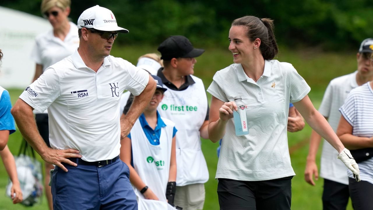 Zach Johnson talks with Iowa basketball player Caitlin Clark, right, while walking on the 16th fairway during the John Deere Classic golf tournament Pro-Am, Wednesday, July 5, 2023, at TPC Deere Run in Silvis, Ill. (AP Photo/Charlie Neibergall)