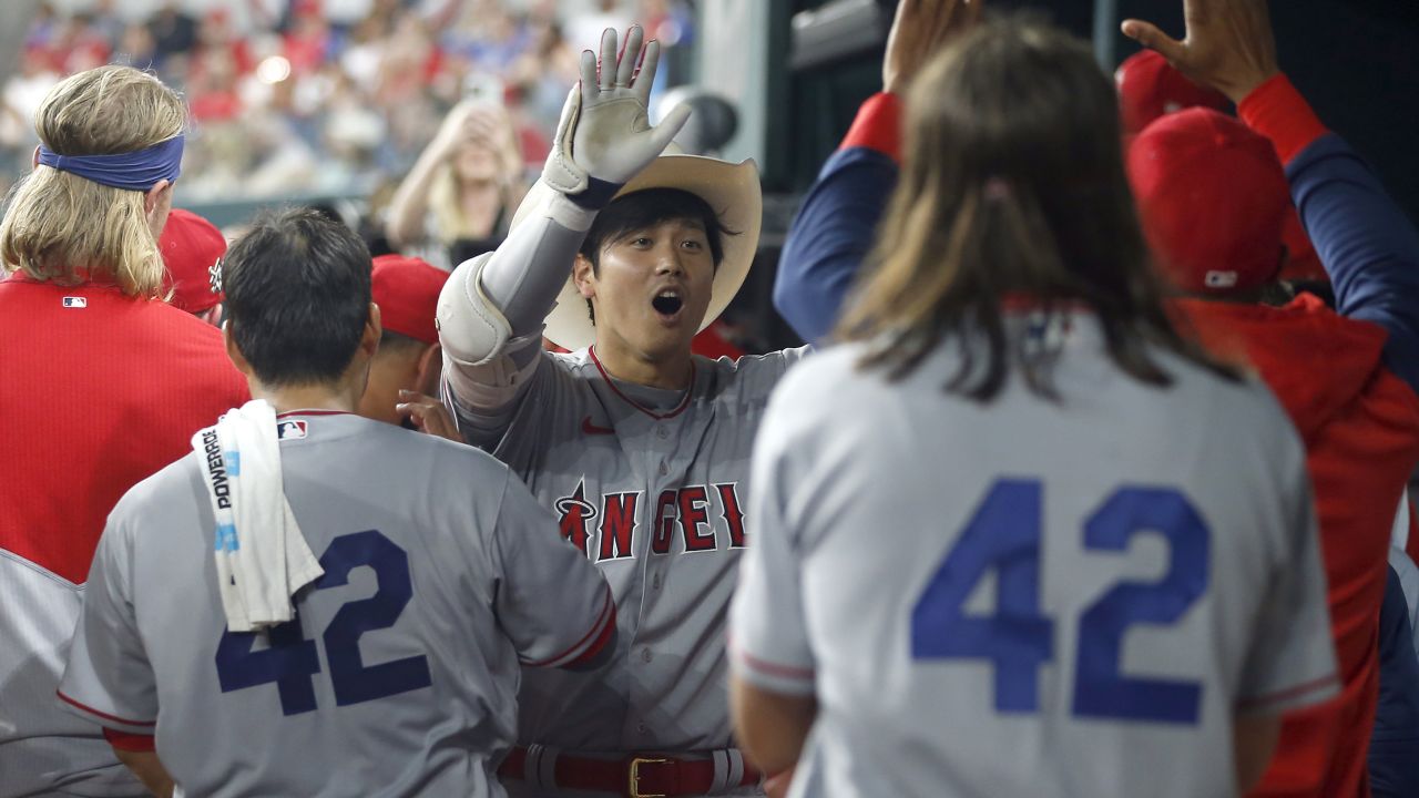 ARLINGTON, TEXAS - APRIL 15: Shohei Ohtani #17 of the Los Angeles Angels is congratulated after hitting a home run in the fifth inning against the Texas Rangers at Globe Life Field on April 15, 2022 in Arlington, Texas. All players are wearing the number 42 in honor of Jackie Robinson Day.   (Photo by Tim Heitman/Getty Images)