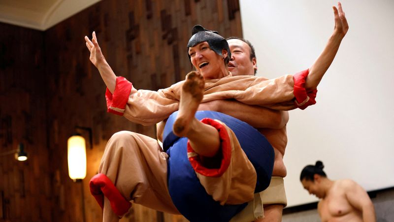 Sumo retirees play for laughs from tourists flooding back to Japan