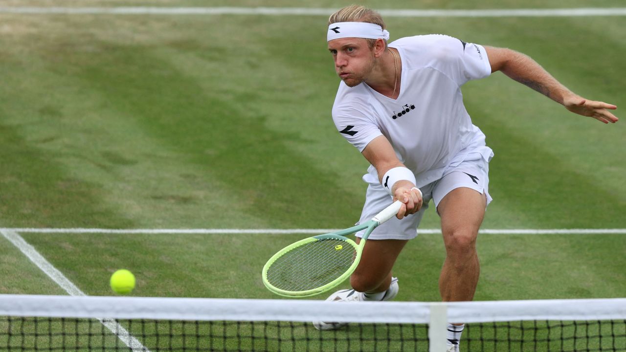 Spain's Alejandro Davidovich Fokina returns the ball to Denmark's Holger Rune during their men's singles tennis match on the sixth day of the 2023 Wimbledon Championships at The All England Tennis Club in Wimbledon, southwest London, on July 8, 2023.