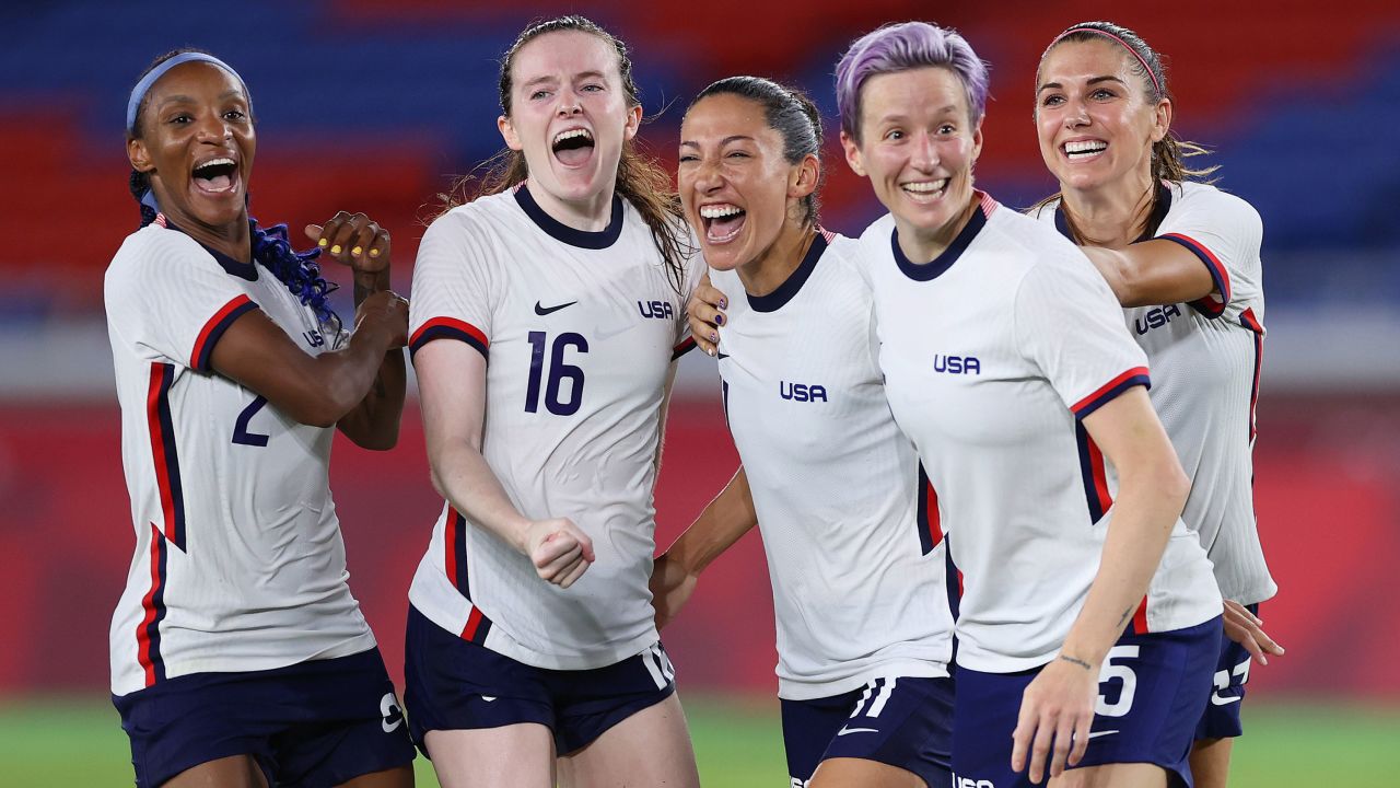 YOKOHAMA, JAPAN - JULY 30: Crystal Dunn #2, Rose Lavelle #16, Christen Press #11, Megan Rapinoe #15 and Alex Morgan #13 of Team United States celebrate following their team's victory in the penalty shoot out after the Women's Quarter Final match between Netherlands and United States on day seven of the Tokyo 2020 Olympic Games at International Stadium Yokohama on July 30, 2021 in Yokohama, Kanagawa, Japan. (Photo by Laurence Griffiths/Getty Images)