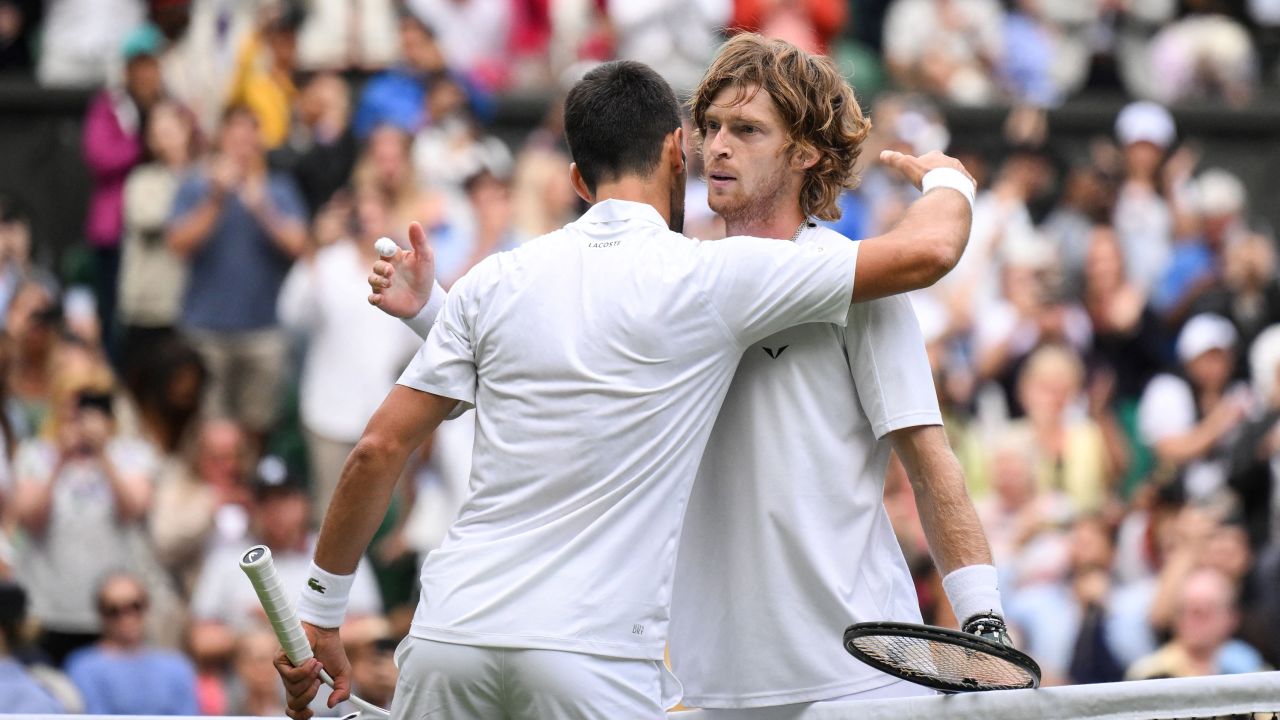 Novak Djokovic and Andrey Rublev embrace after their thrilling clash.