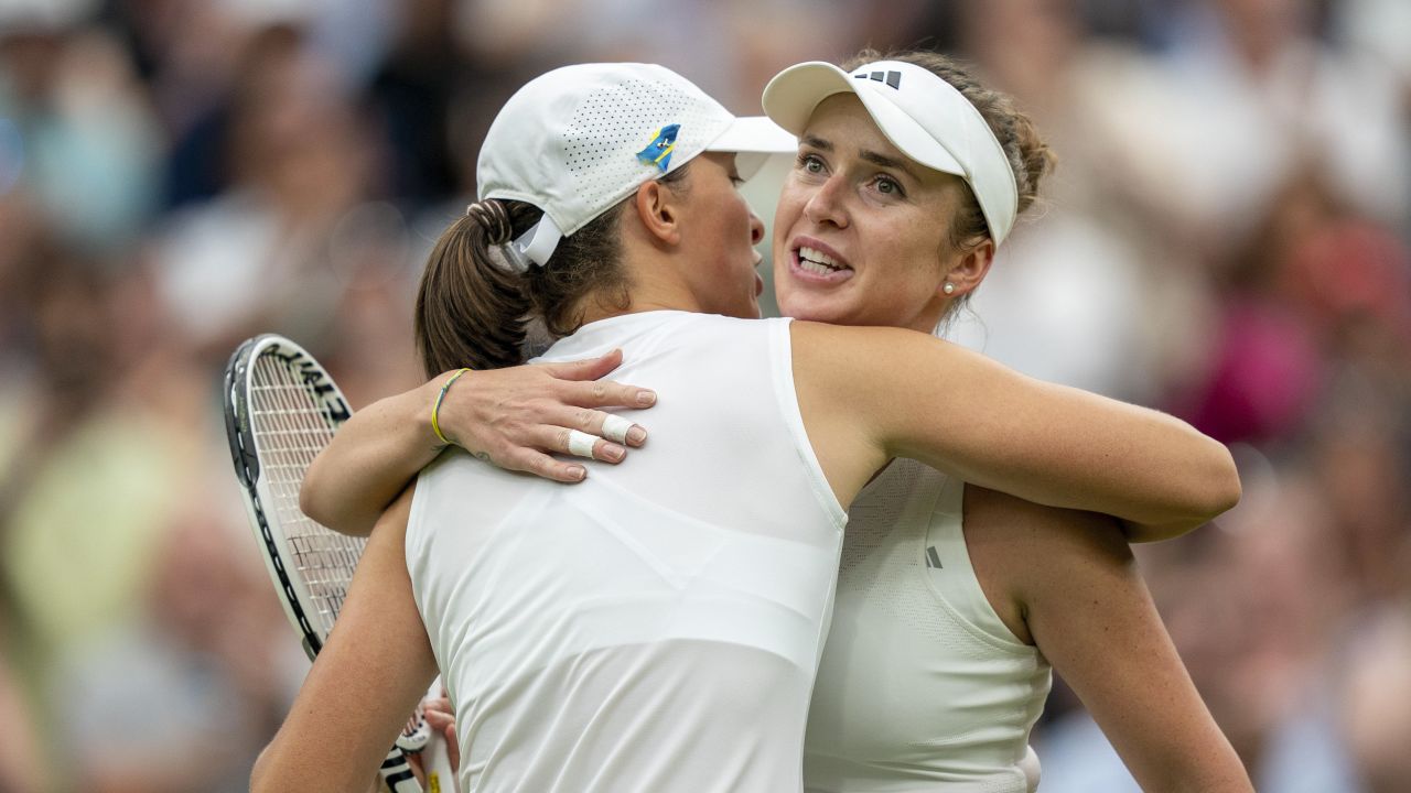 Jul 11, 2023; London, United Kingdom; Elina Svitolina (UKR) at the net with Iga Swiatek (POL) after their match on day nine at the All England Lawn Tennis and Croquet Club.  Mandatory Credit: Susan Mullane-USA TODAY Sports