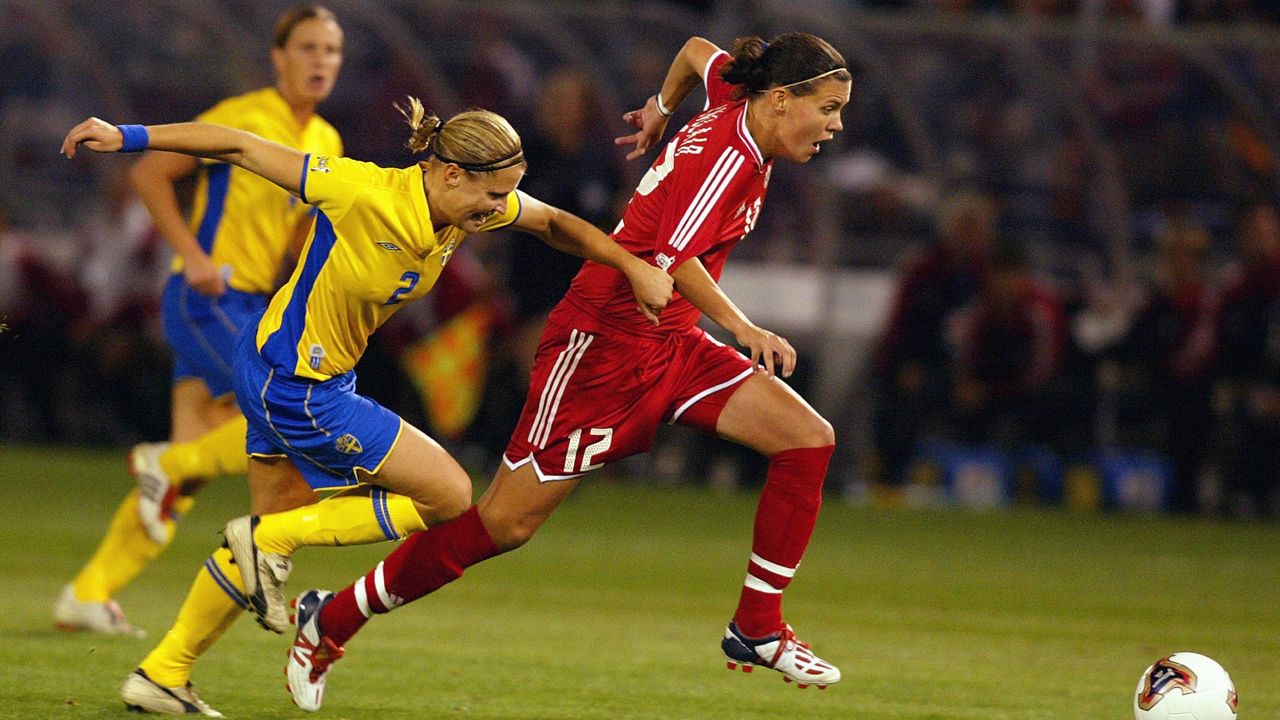 PORTLAND, OR - OCTOBER 5:  Christine Sinclair #12 of Canada dribbles against the defense of Karolina Westberg #2 of Sweden during the semifinals of the FIFA Women's World Cup  match on October 5, 2003 at PGE Park in Portland, Oregon. (Photo by Ben Radford/Getty Images)