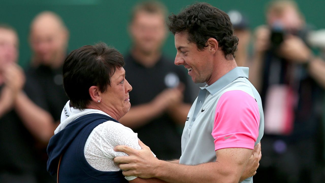 Northern Ireland's Rory McIlroy celebrates with his mother Rosie on the 18th green winning the Open Championship after his fourth round 71, on the final day of the 2014 British Open Golf Championship at Royal Liverpool Golf Course in Hoylake, north west England on July 20, 2014. McIlroy won the British Open at Royal Liverpool Golf Course in Hoylake with a final round of 71. The 25-year-old Northern Irishman won with a seventeen under par total of 271, two strokes clear of Rickie Fowler and Sergio Garcia. AFP PHOTO / ANDREW YATES        (Photo credit should read ANDREW YATES/AFP via Getty Images)